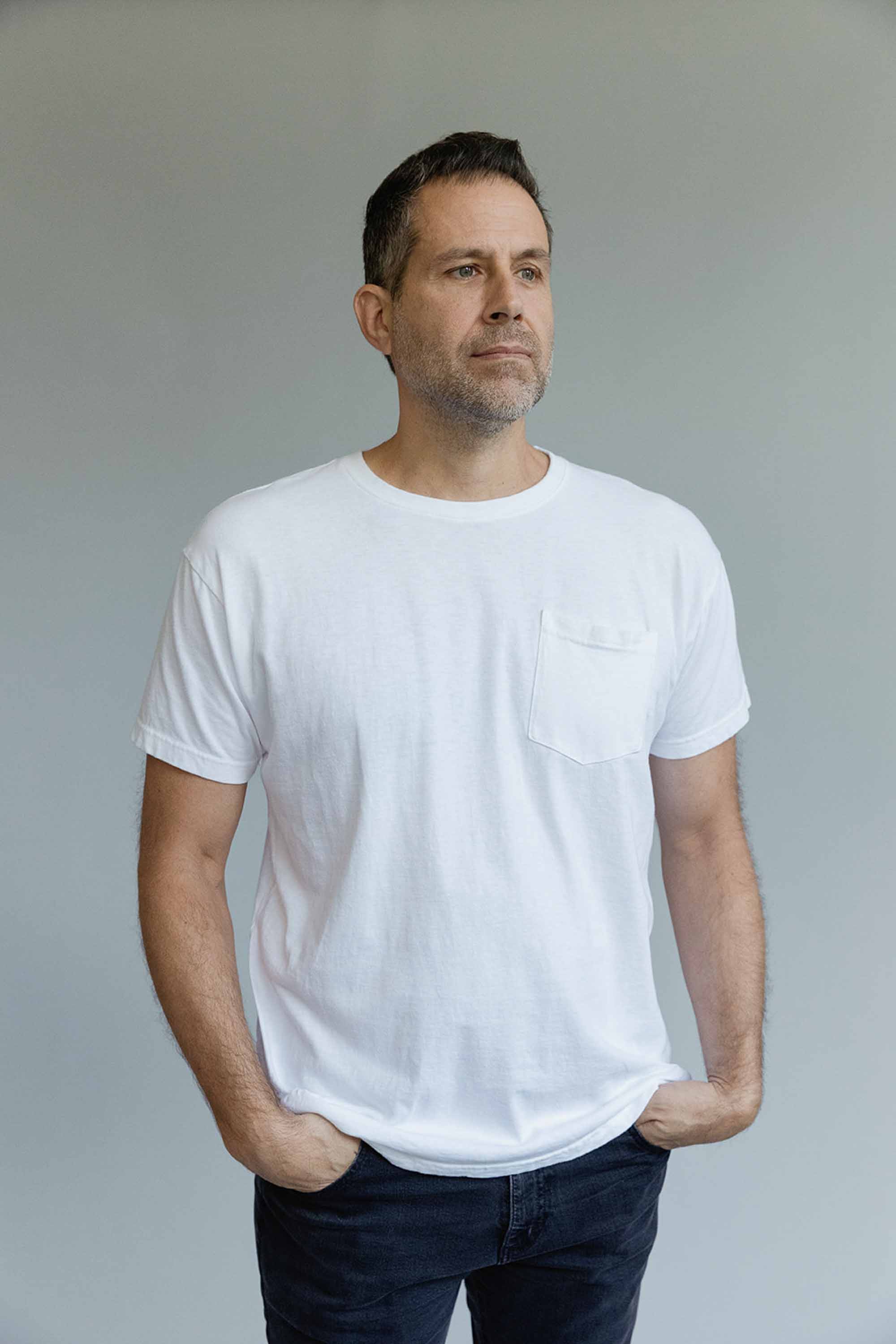 A man wearing a white pocket t-shirt