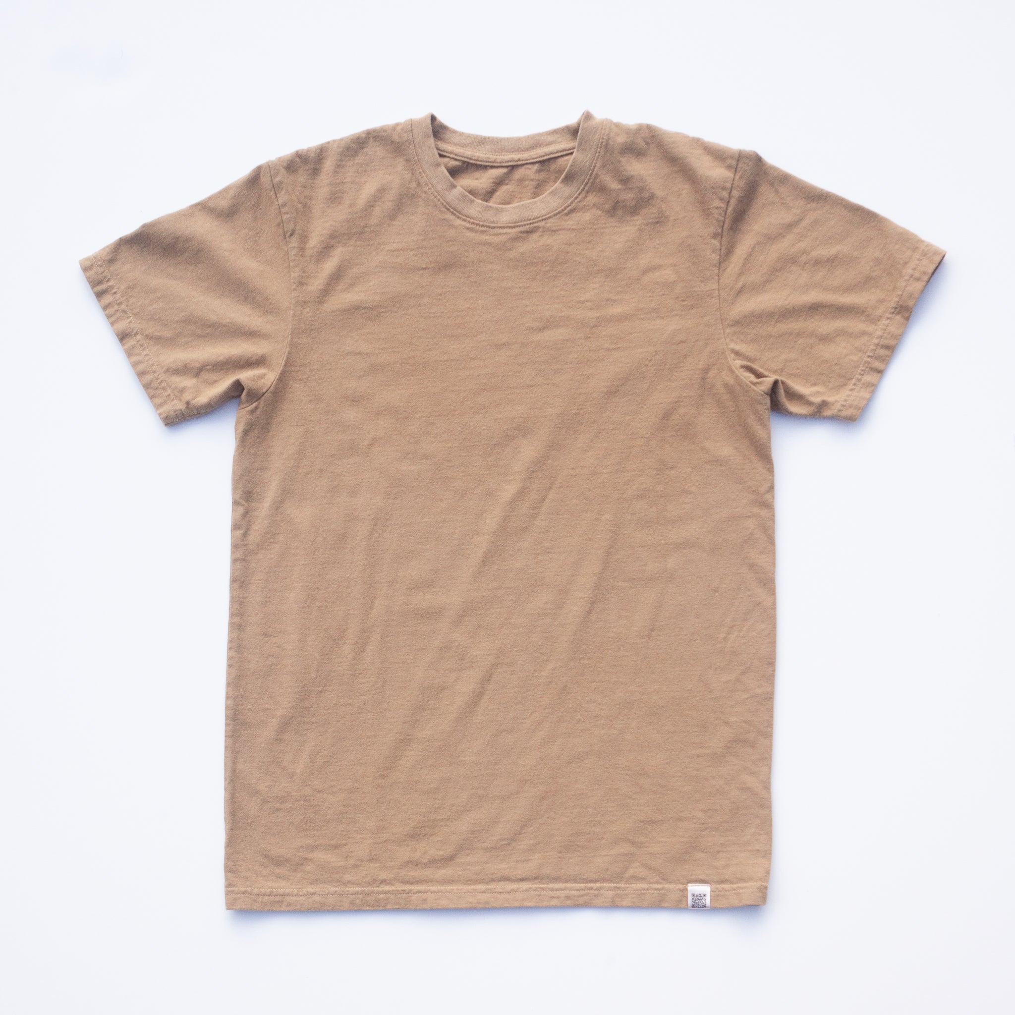 A Solid State Clothing North Carolina Black Walnut Shirt lies against a white background. The color of the shirt is a lighter, muted shade of brown
